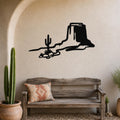 Black metal wall art silhouette of a desert mesa and cactus, mounted above a wooden bench in a southwestern-style entryway.