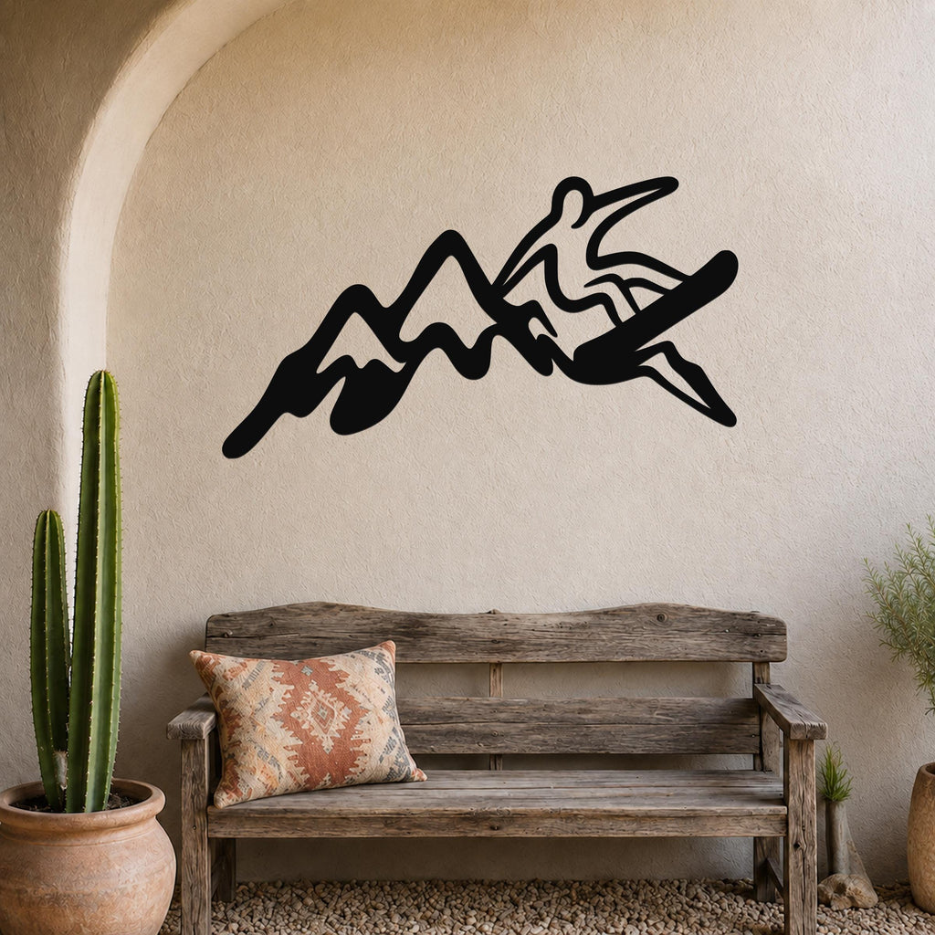 Black metal wall art silhouette of a snowboarder in motion above a wooden bench in a rustic entryway.
