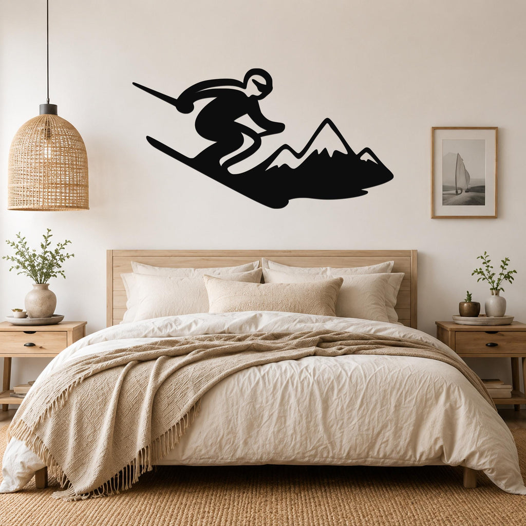 Black metal wall art silhouette of a skier in motion above a bed, mounted on a light-colored bedroom wall.