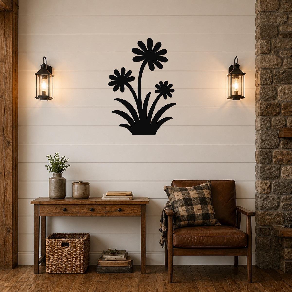 Black metal wall art featuring a silhouette of three daisies with long stems and leaves, mounted on a shiplap wall above a wooden console table in a living room.