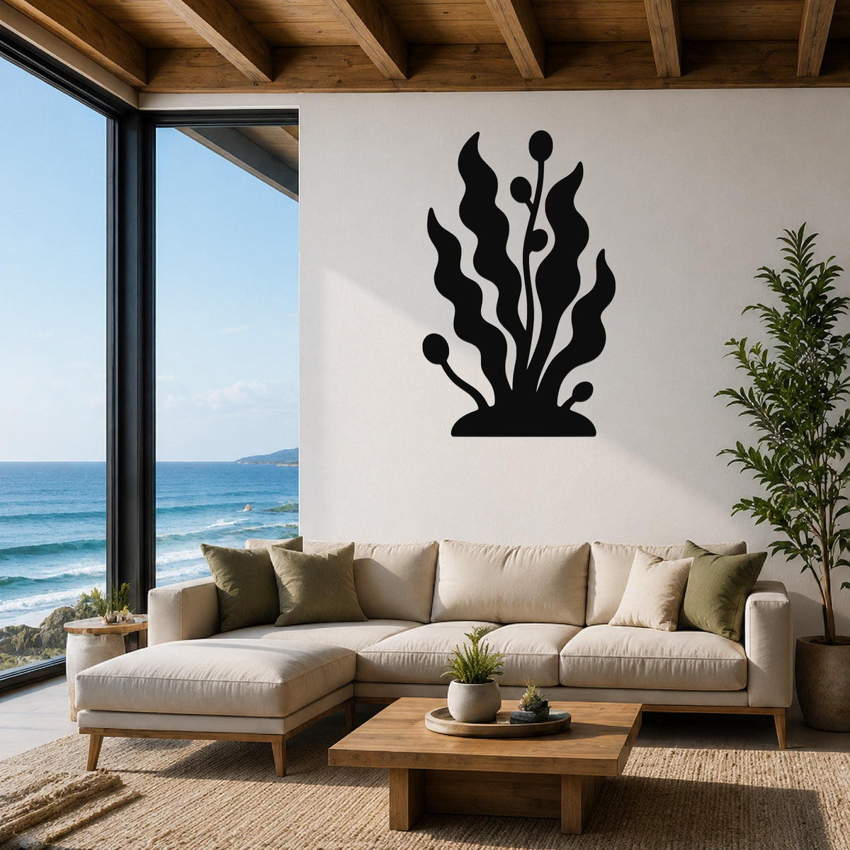 Black metal wall art in a kelp and seaweed silhouette, mounted above a beige sectional sofa in a coastal living room with ocean views.