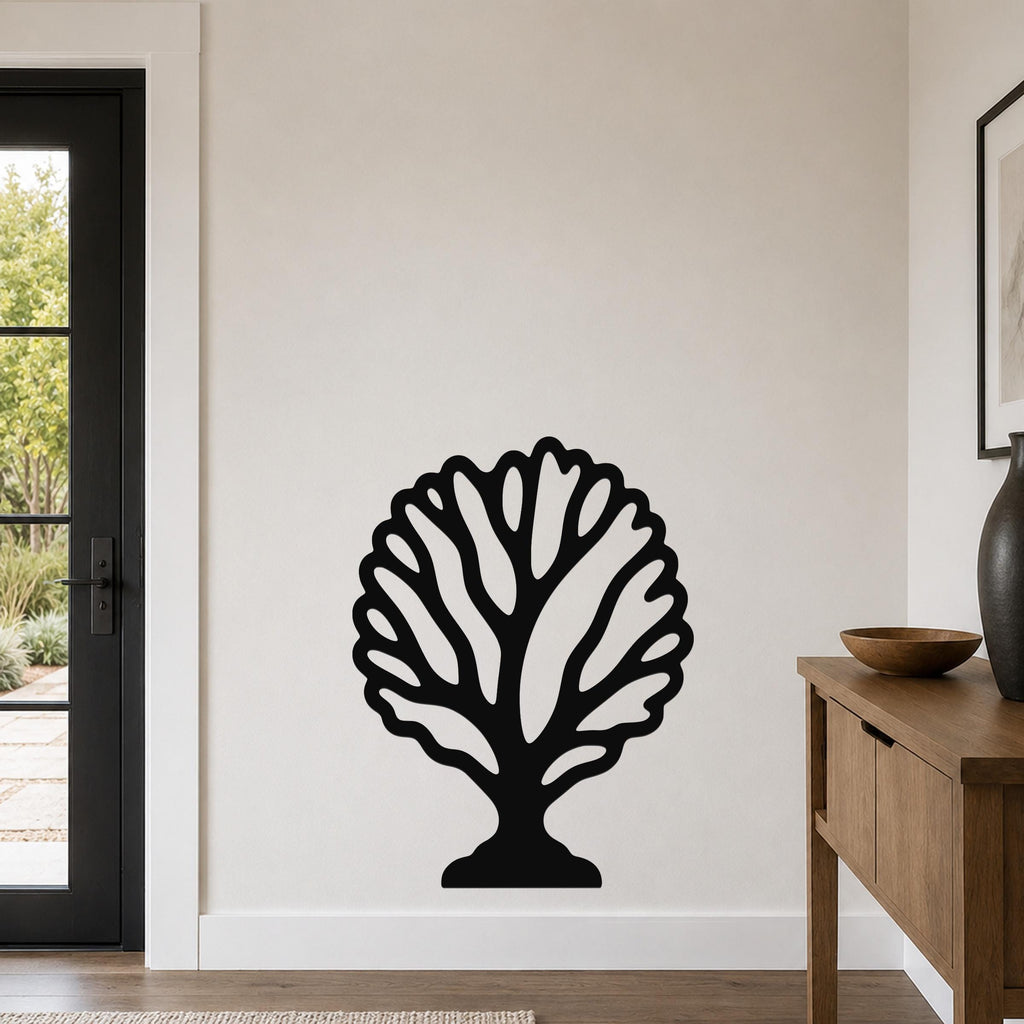 Black metal fan coral wall art with intricate cutout branches, mounted on a white wall in a modern entryway.
