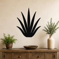 Black metal agave wall art with pointed leaf cutouts, mounted on a beige wall above a wooden console table in a living room.
