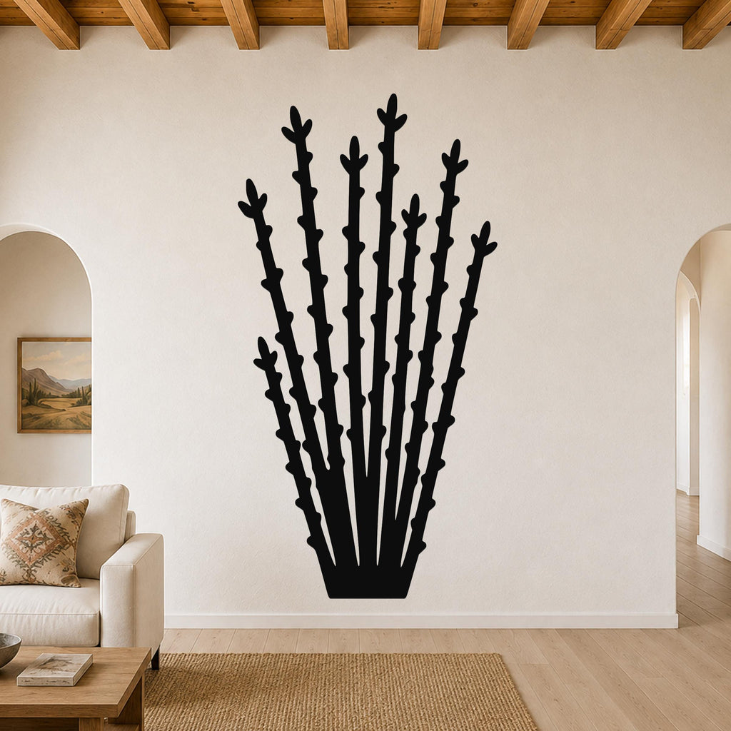 Black metal ocotillo wall art with spiky branch cutouts, mounted on a living room wall above a sofa.