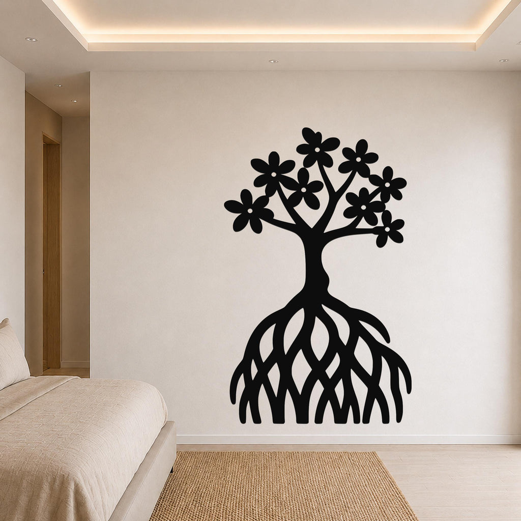 Black metal wall art of a tree with flower-shaped leaves and exposed roots, mounted on a bedroom wall above a bed.