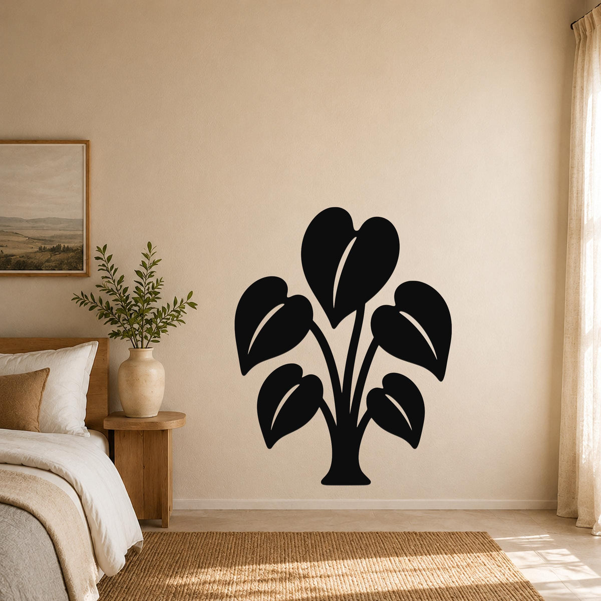 Black metal wall art in the shape of an elephant ear plant with large leaf cutouts, mounted on a beige bedroom wall above a woven rug.