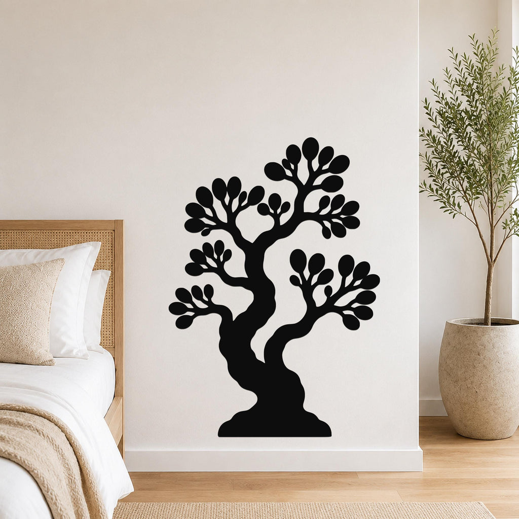 Black metal wall art silhouette of a bonsai tree with layered branches and leaf clusters, mounted on a white bedroom wall above a bed.