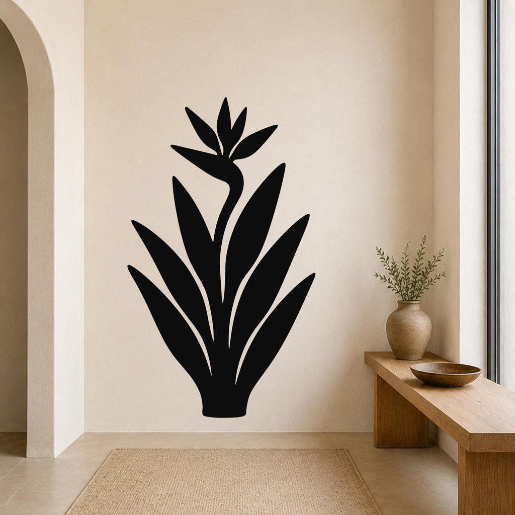 Black metal Bird of Paradise wall art with a silhouette design, mounted on a beige wall above a wooden bench in a minimalist entryway.