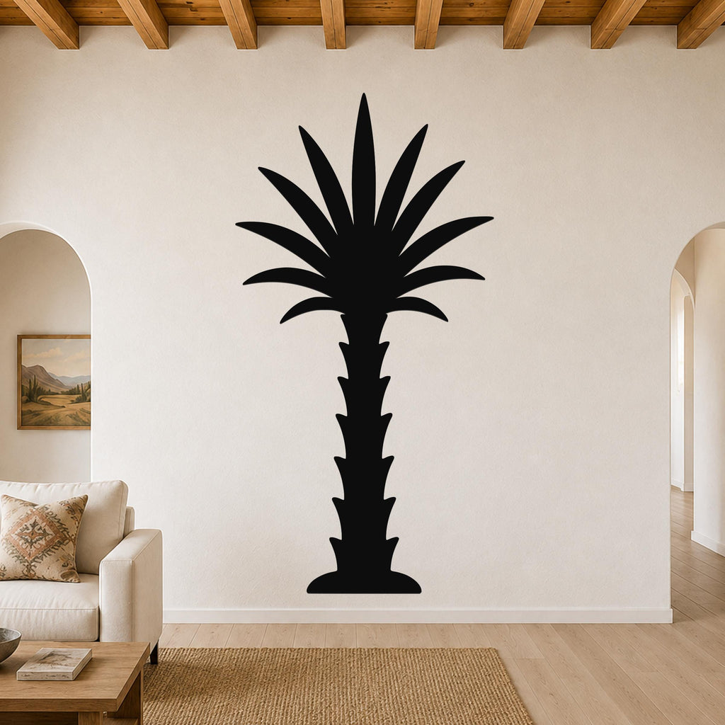 Black metal palm tree wall art with a silhouette design, mounted on a living room wall above a sofa.