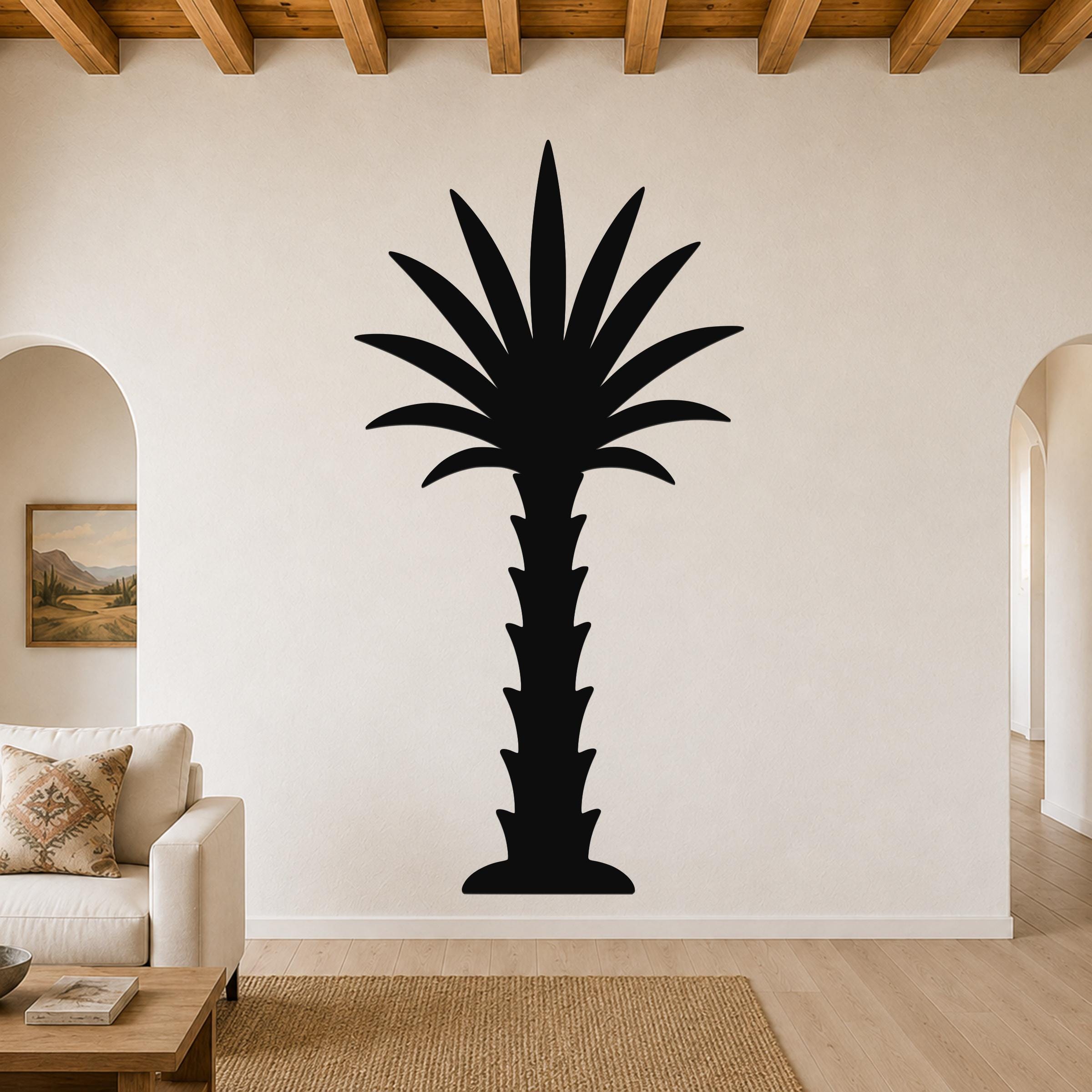 Black metal palm tree wall art with a silhouette design, mounted on a living room wall above a sofa.