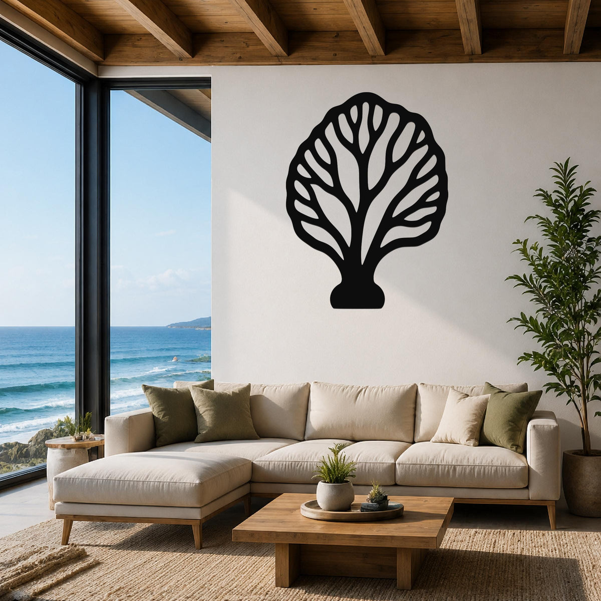 Black metal fan coral wall art with intricate branch cutouts, mounted above a beige sectional sofa in a coastal living room with ocean views.