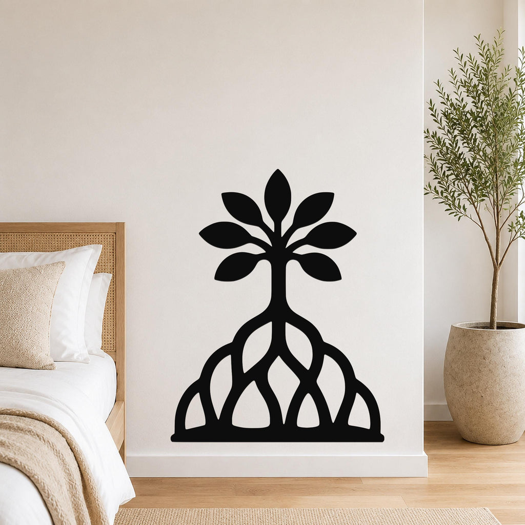 Black metal wall art in a tree silhouette with leafy canopy and exposed root cutouts, mounted on a bedroom wall above a bed.