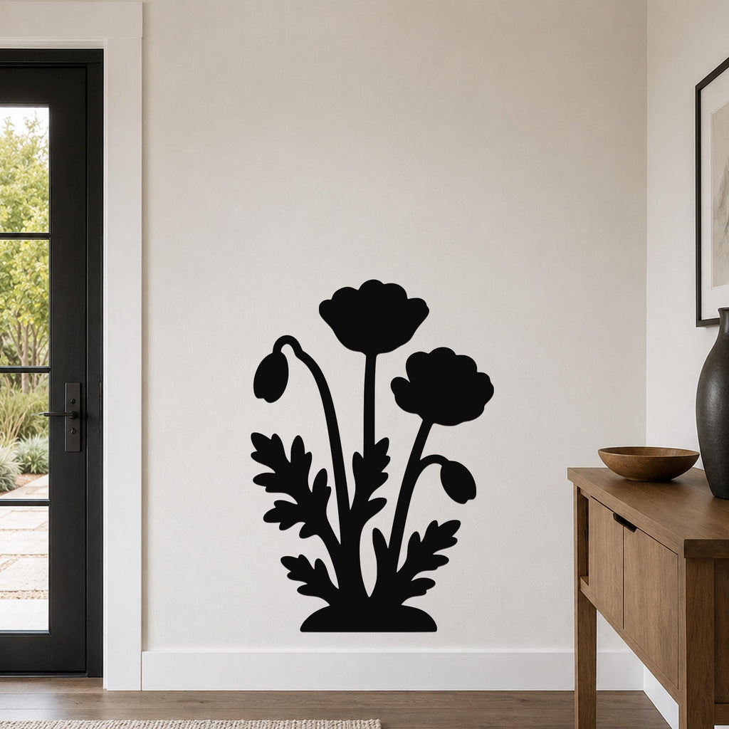 Black metal wall art with a silhouette of poppy flowers and leaves, mounted on a living room wall above a wooden console table.
