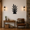 Black metal cattail wall art silhouette mounted on a shiplap wall above a wooden console table in a rustic living room.