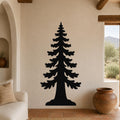 Black metal sequoia tree wall art with layered branch cutouts, mounted on a beige stucco wall in a living room with terracotta flooring and wooden beams.