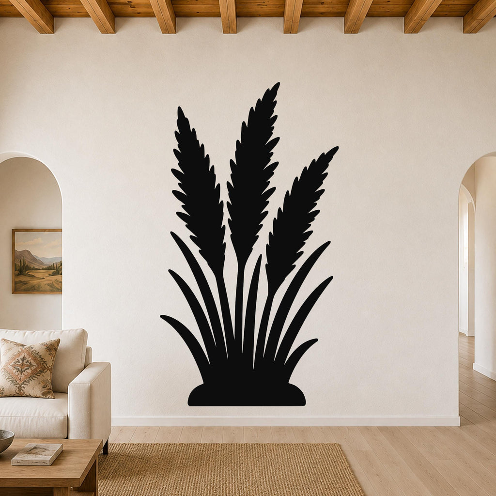 Black metal wall art in a wild grass silhouette design, mounted on a living room wall above a beige sofa.