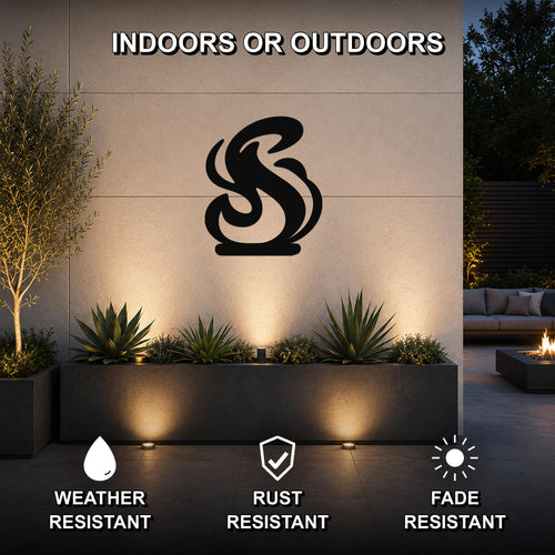 Black metal flame silhouette wall art mounted on an outdoor wall above a planter, with visible weather, rust, and fade resistance icons.