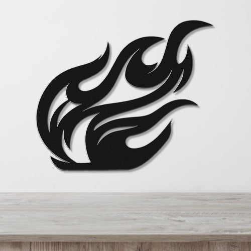 Black metal wall art with a fluid flame silhouette design, featuring layered cutouts and a dynamic shape, mounted on a white wall above a wooden surface.