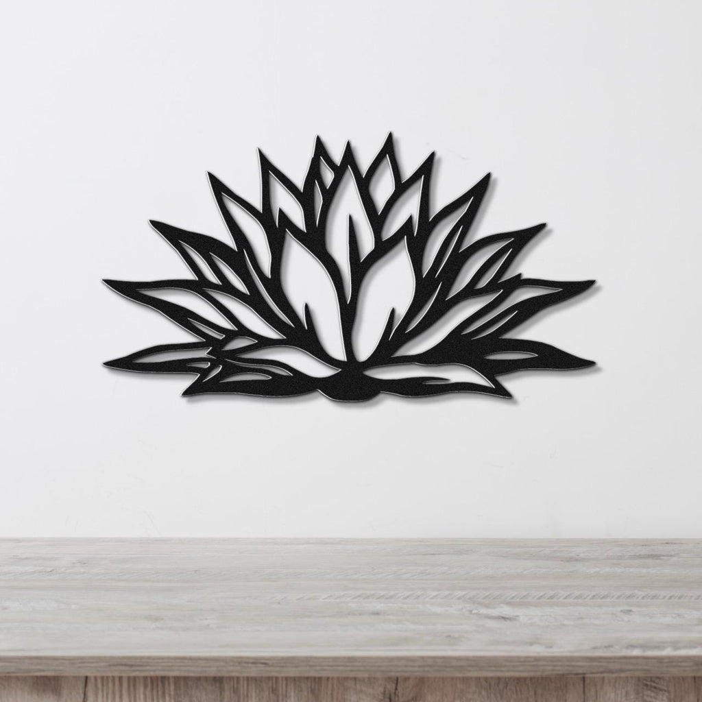 Black metal agave wall art with bold geometric cutouts, mounted on a white wall above a light wood counter.