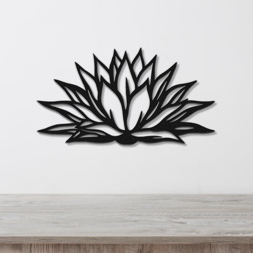 Black metal agave wall art with bold geometric cutouts, mounted on a white wall above a light wood counter.