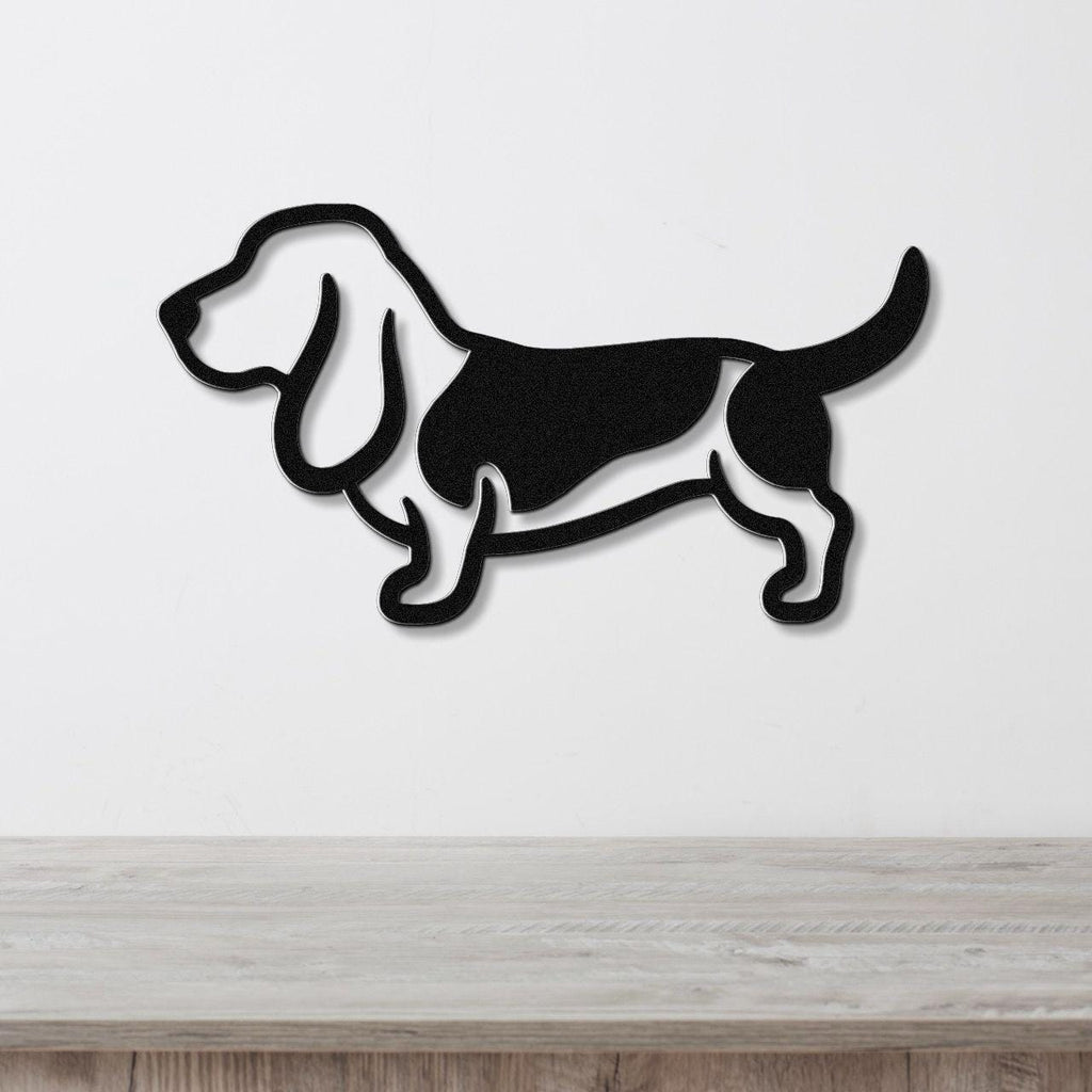 Black metal Basset Hound wall art silhouette with cutout details, mounted on a white wall above a light wood counter.