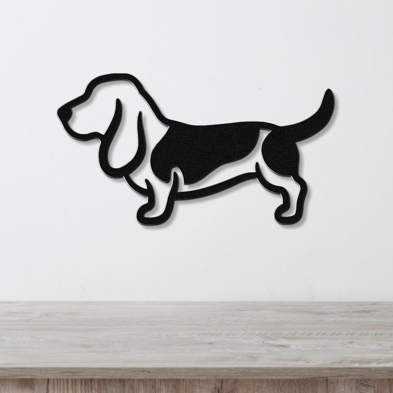 Black metal Basset Hound wall art silhouette with cutout details, mounted on a white wall above a light wood counter.