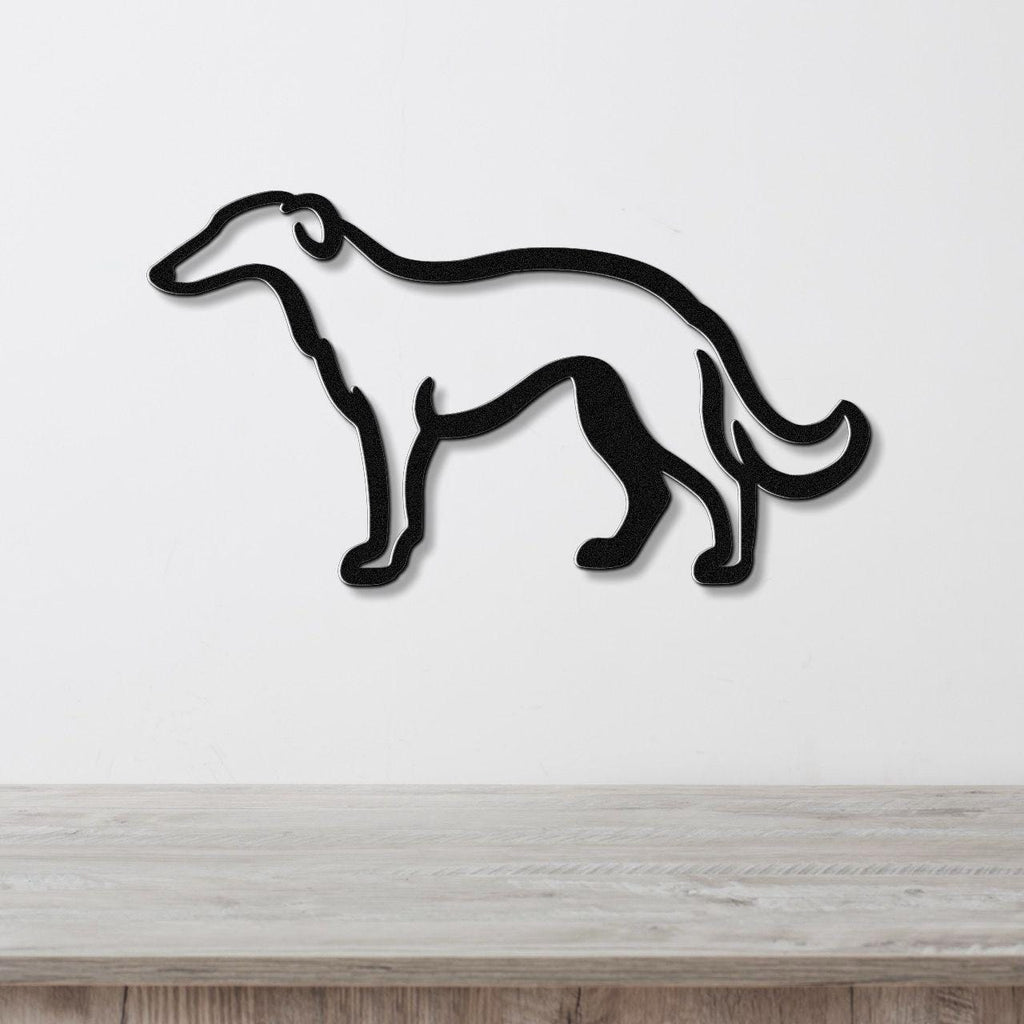 Black metal wall art in the silhouette of a Borzoi dog, mounted on a white wall above a light wood surface.