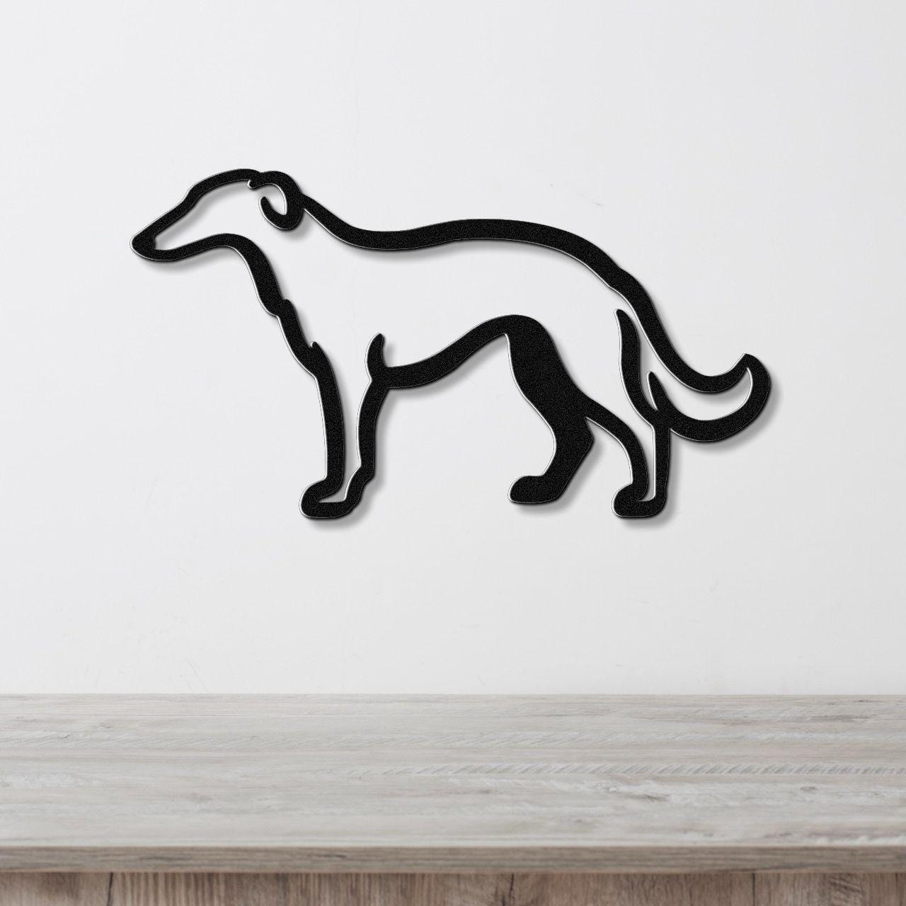 Black metal wall art in the silhouette of a Borzoi dog, mounted on a white wall above a light wood surface.