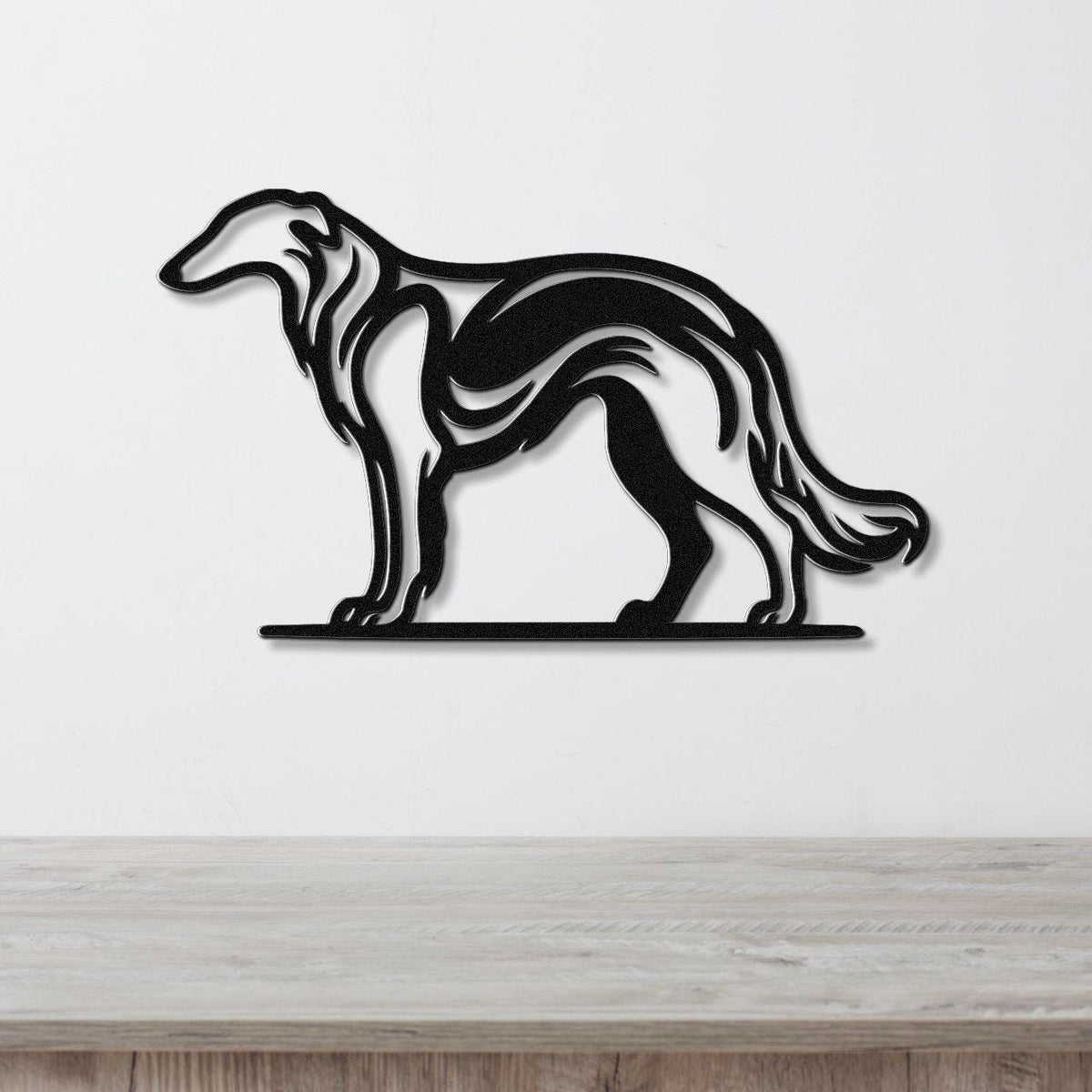 Black metal Borzoi dog wall art with flowing motion-line cutouts, mounted on a white wall above a light wood counter.
