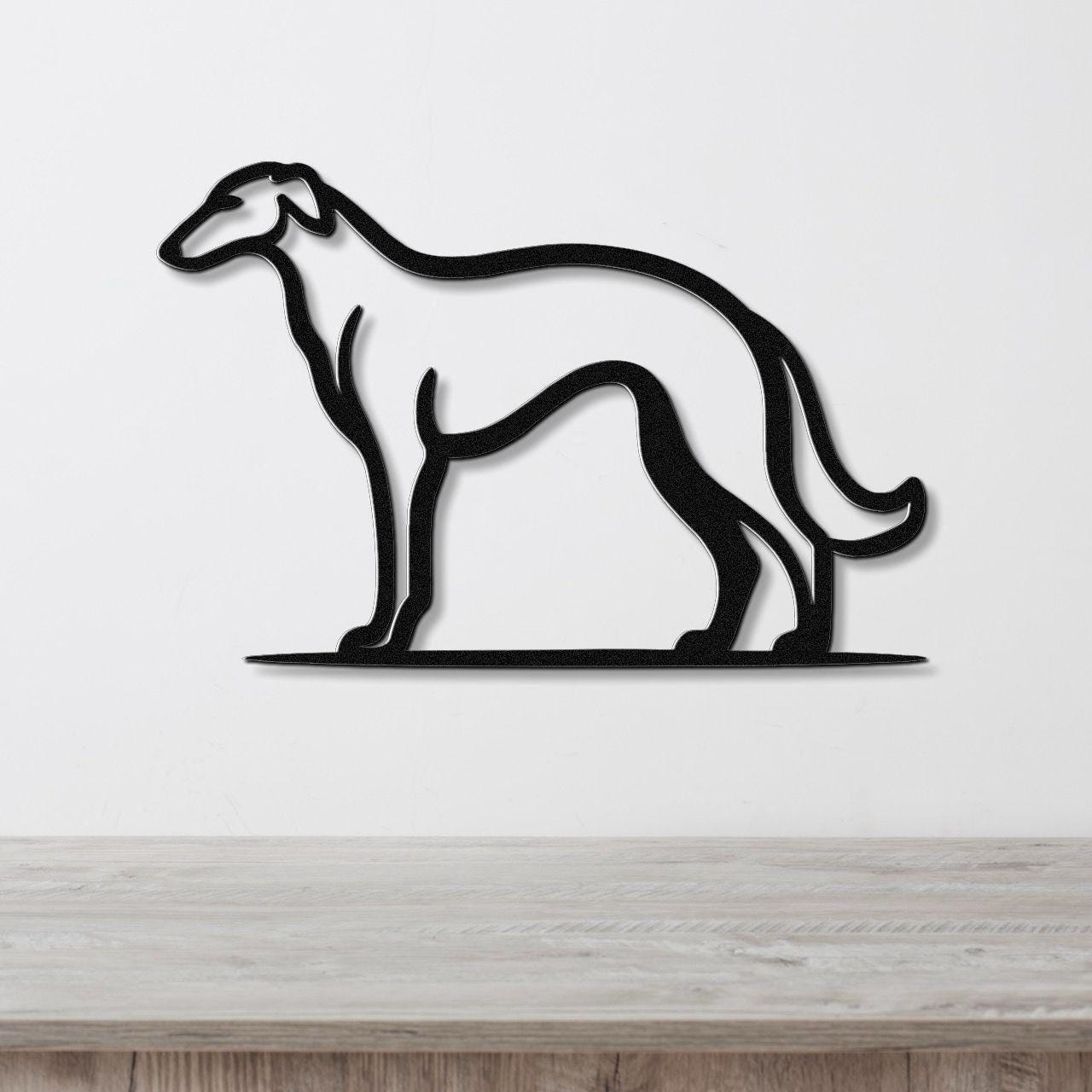 Black metal Borzoi dog wall art silhouette with a powder-coated finish, mounted on a white wall above a light wood surface.
