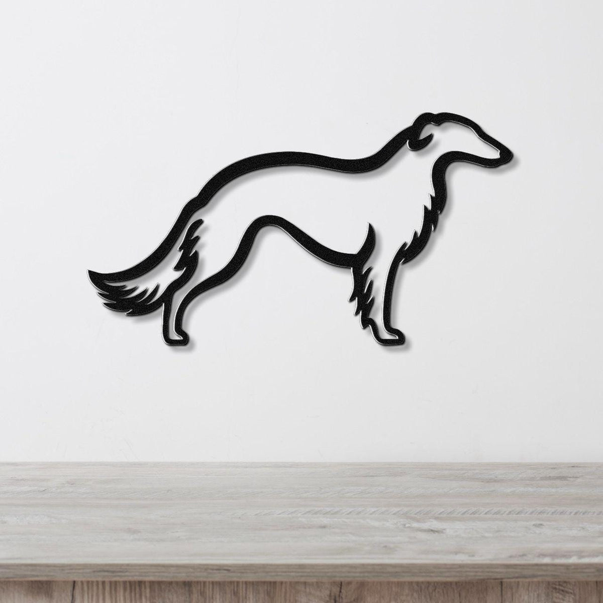 Black metal Borzoi dog wall art silhouette with detailed tail and leg cutouts, mounted on a white wall above a light wood counter.