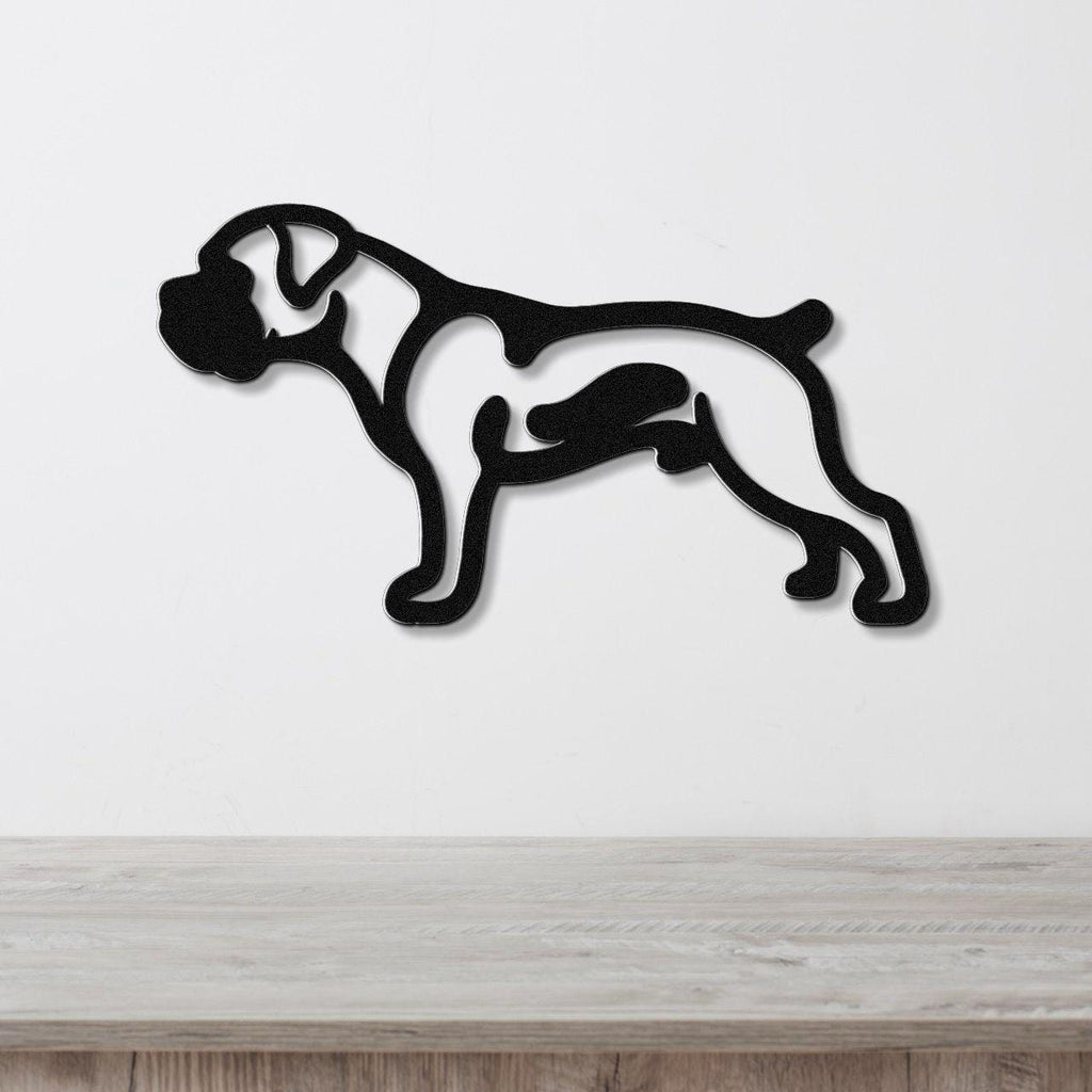 Black metal Boxer dog wall art in silhouette cutout style, mounted on a white wall above a light wood surface.