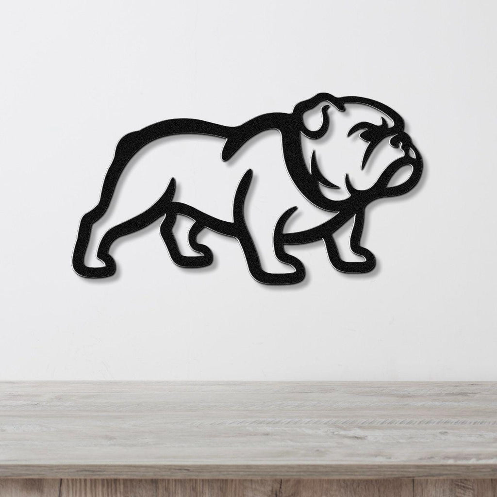 Black metal bulldog wall art with a bold silhouette cutout, mounted on a white wall above a light wood surface.