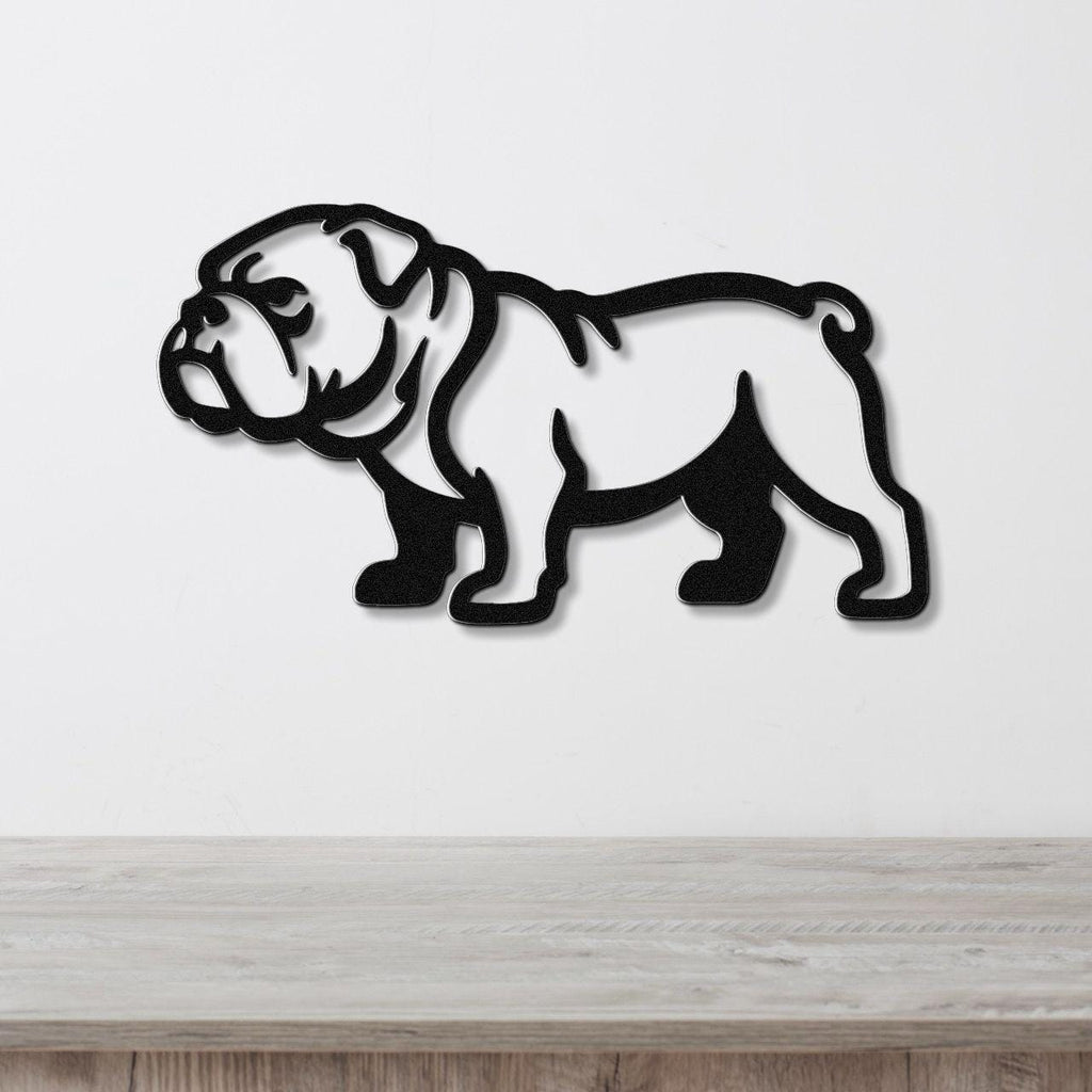 Black metal bulldog wall art with a cutout silhouette design, mounted on a white wall above a light wood surface.