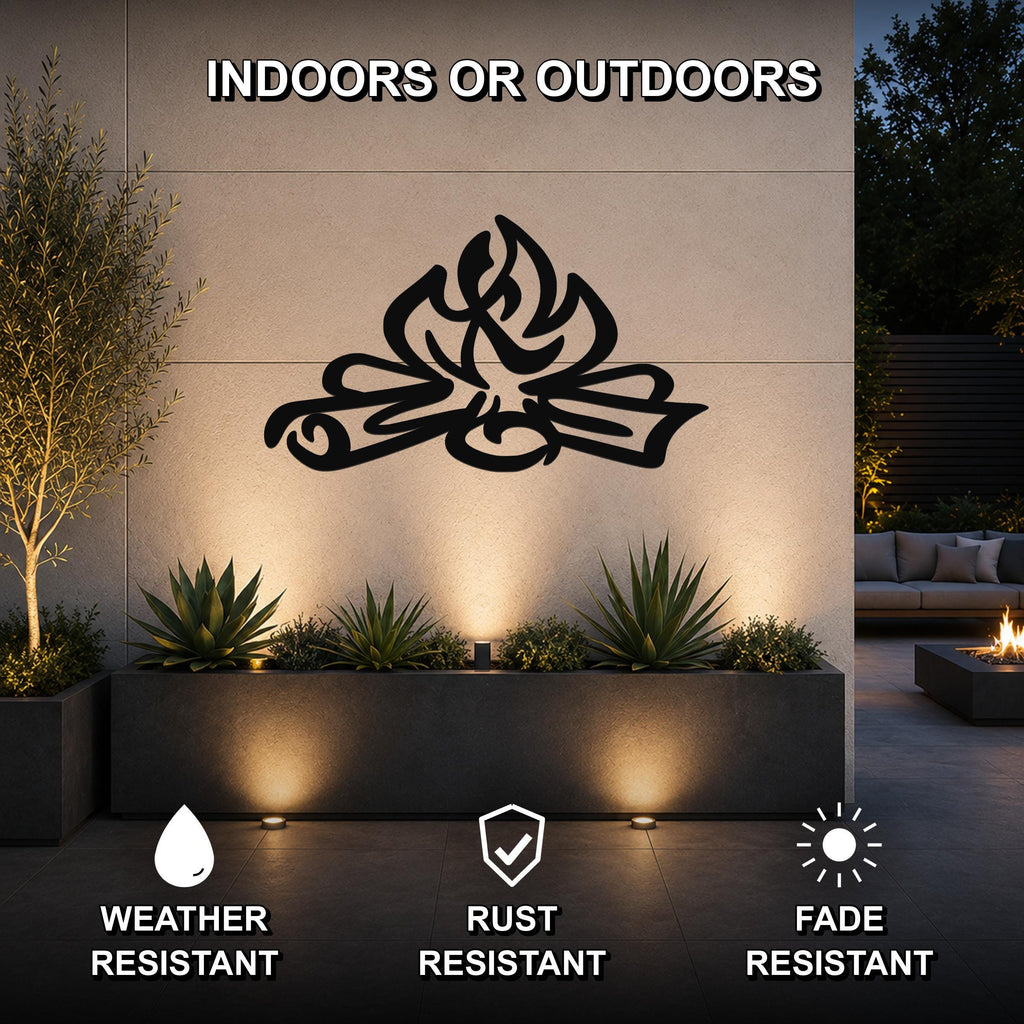 Black metal campfire wall art with flame and log cutouts, mounted on an outdoor wall above a planter in a patio setting.