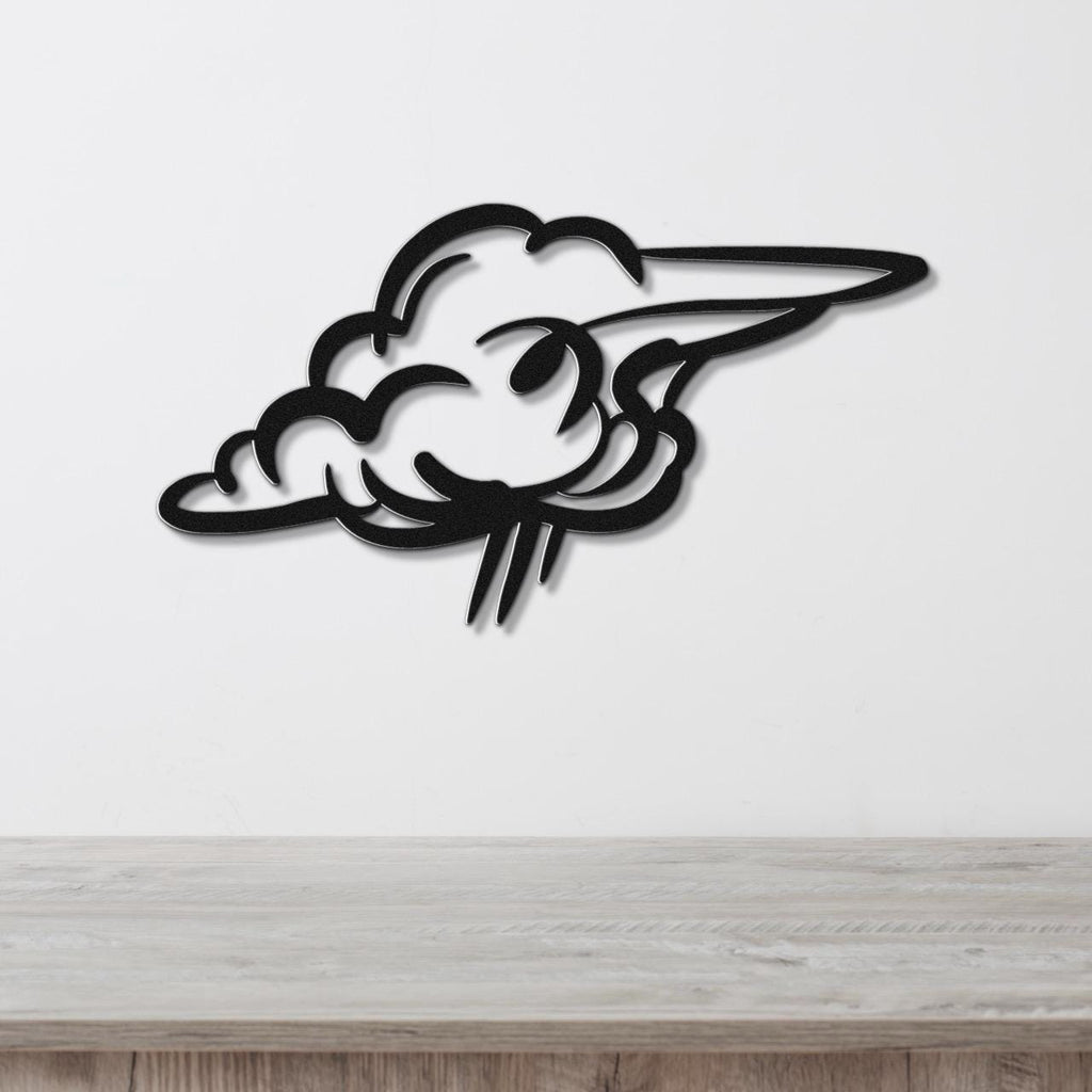 Black metal cloud wall art with a cutout design, mounted on a white wall above a wooden surface.