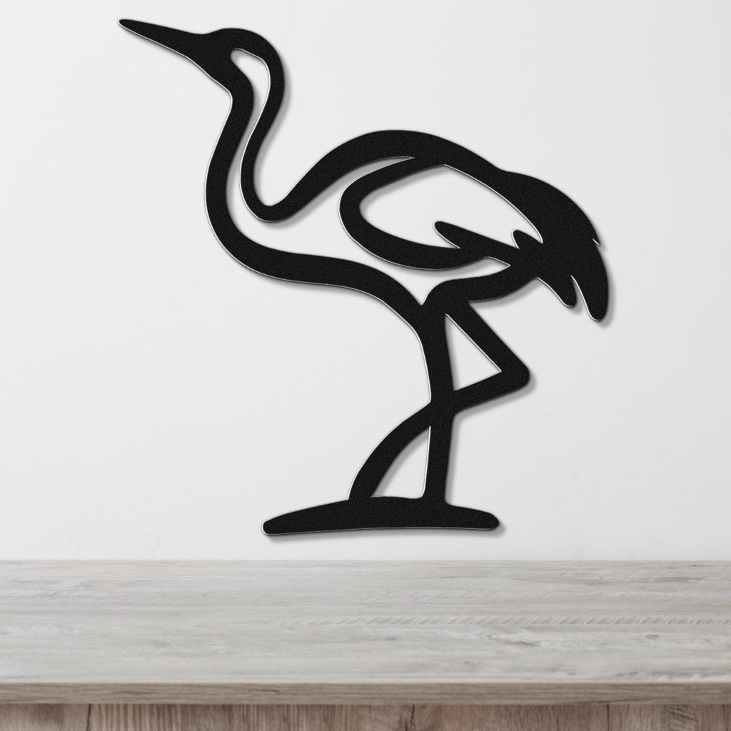 Black metal crane wall art with a minimalist silhouette design, mounted on a white wall above a light wood surface.