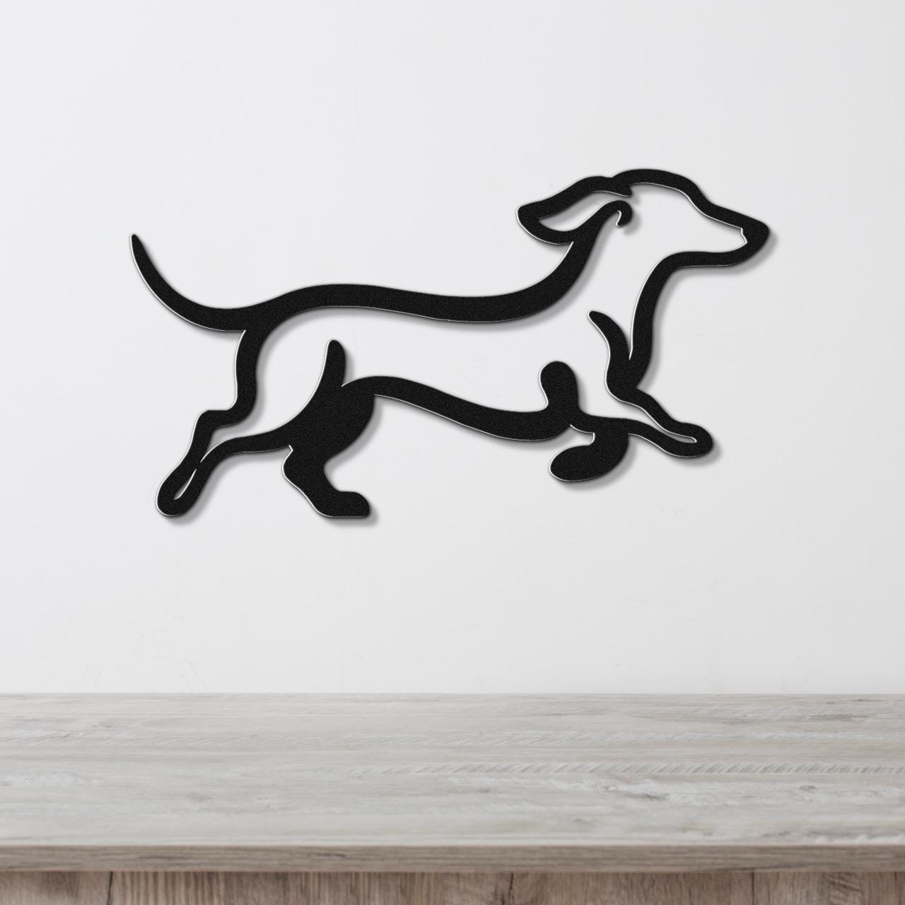 Black metal dachshund wall art with a running silhouette, mounted on a white wall above a light wood counter.