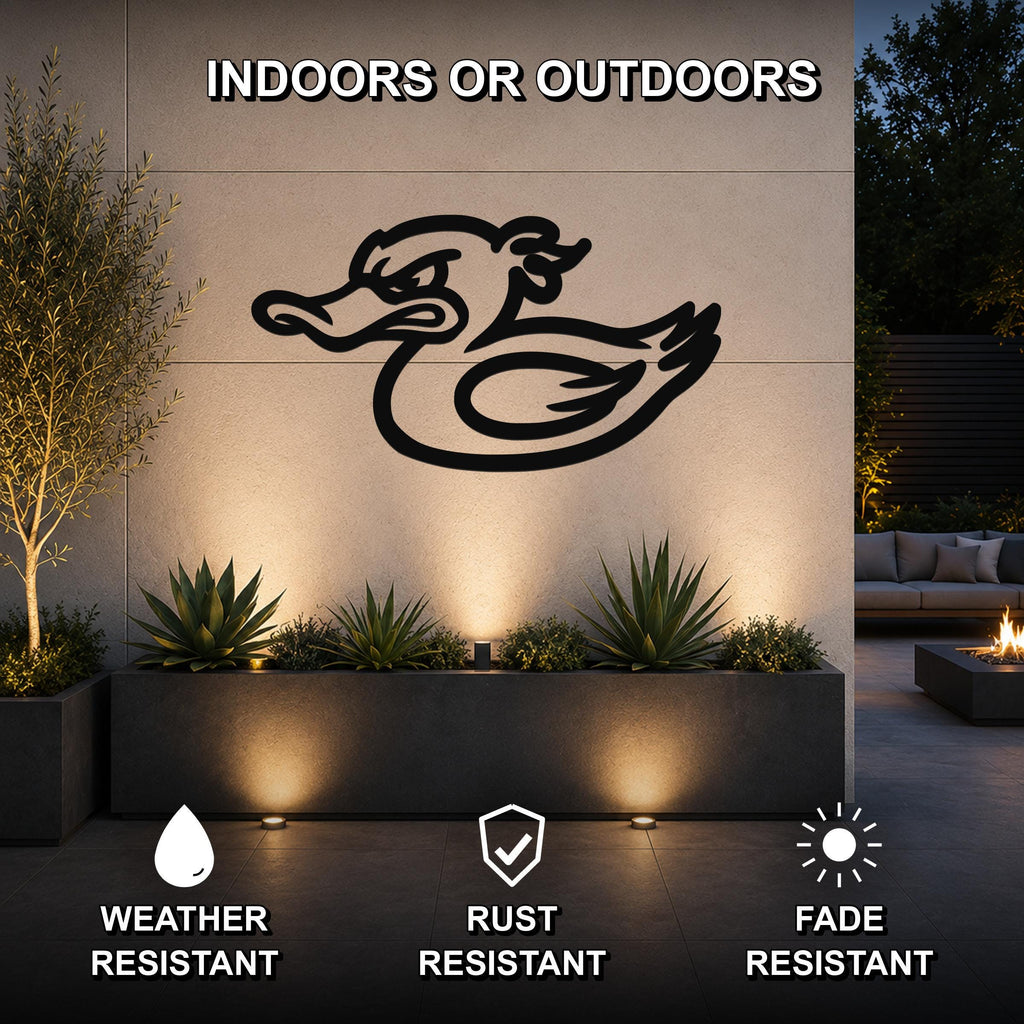 Black metal duck silhouette wall art mounted on an outdoor wall above a planter, with lighting highlighting the design in a patio setting.