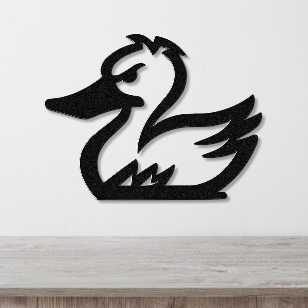 Black metal duck wall art silhouette with cutout details, mounted on a white wall above a light wood surface.
