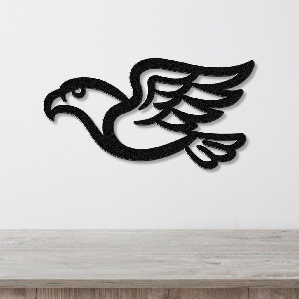 Black metal eagle wall art with wing and tail cutouts, mounted on a white wall above a light wood surface.