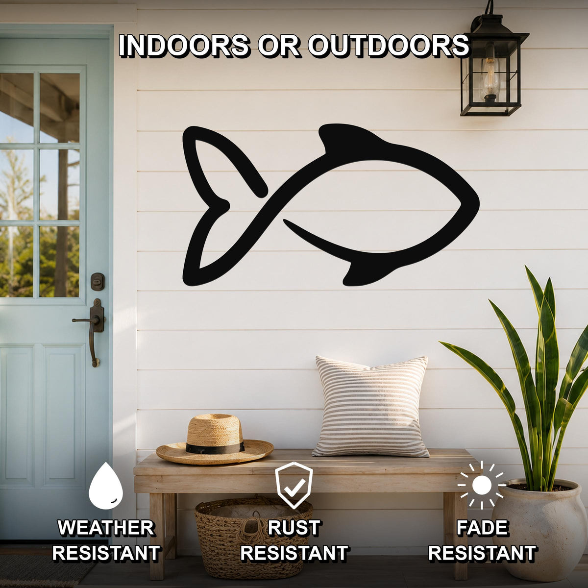 Black metal fish wall art silhouette mounted on a white shiplap wall above a wooden bench in a porch entryway.