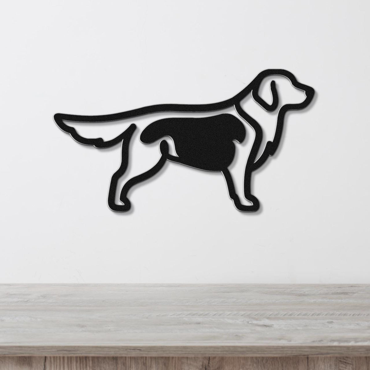 Black metal wall art of a golden retriever in silhouette, mounted on a white wall above a light wood surface.