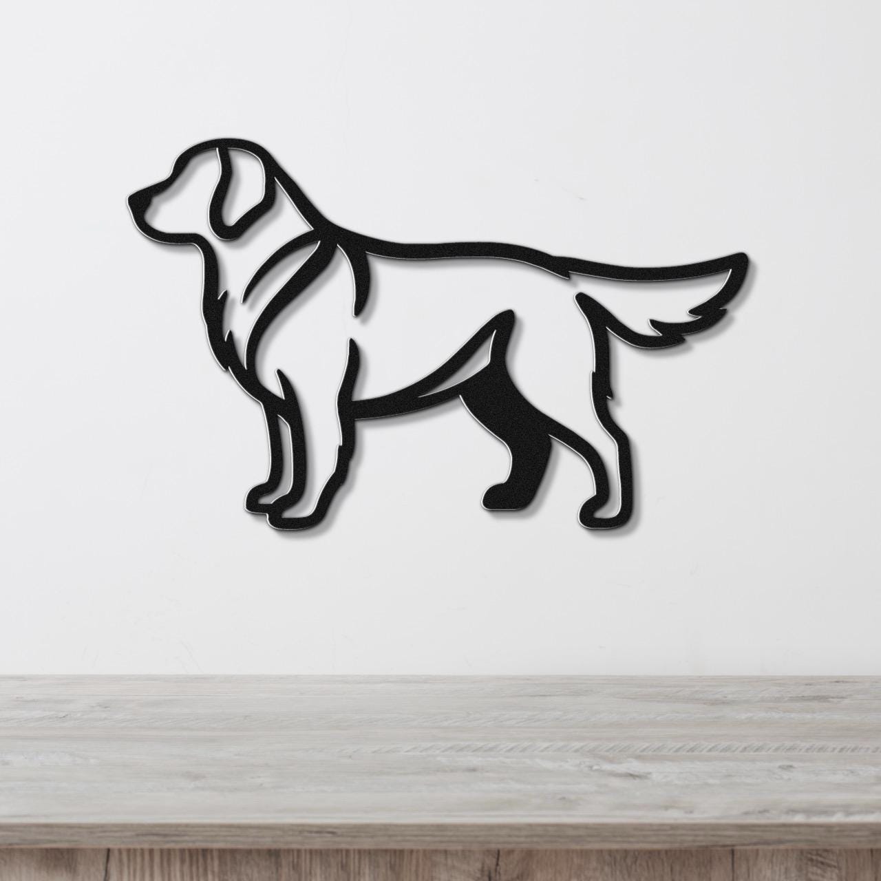 Black metal wall art cutout of a standing golden retriever, mounted on a white wall above a light wood surface.