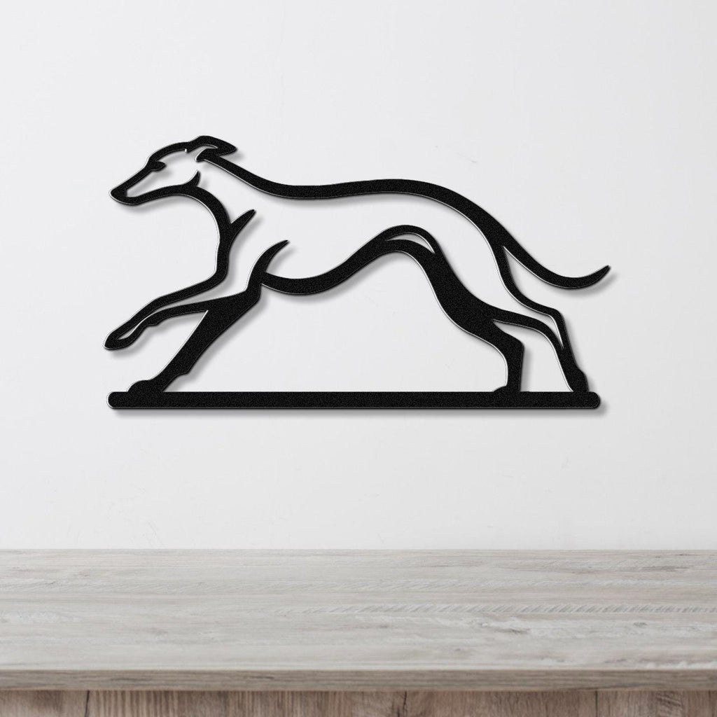 Black metal greyhound wall art silhouette with motion-line cutouts, mounted on a white wall above a light wood counter.