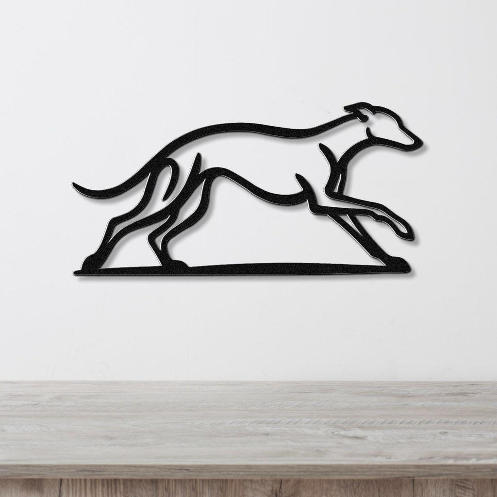 Black metal greyhound wall art with motion-line cutouts, mounted on a white wall above a light wood counter.