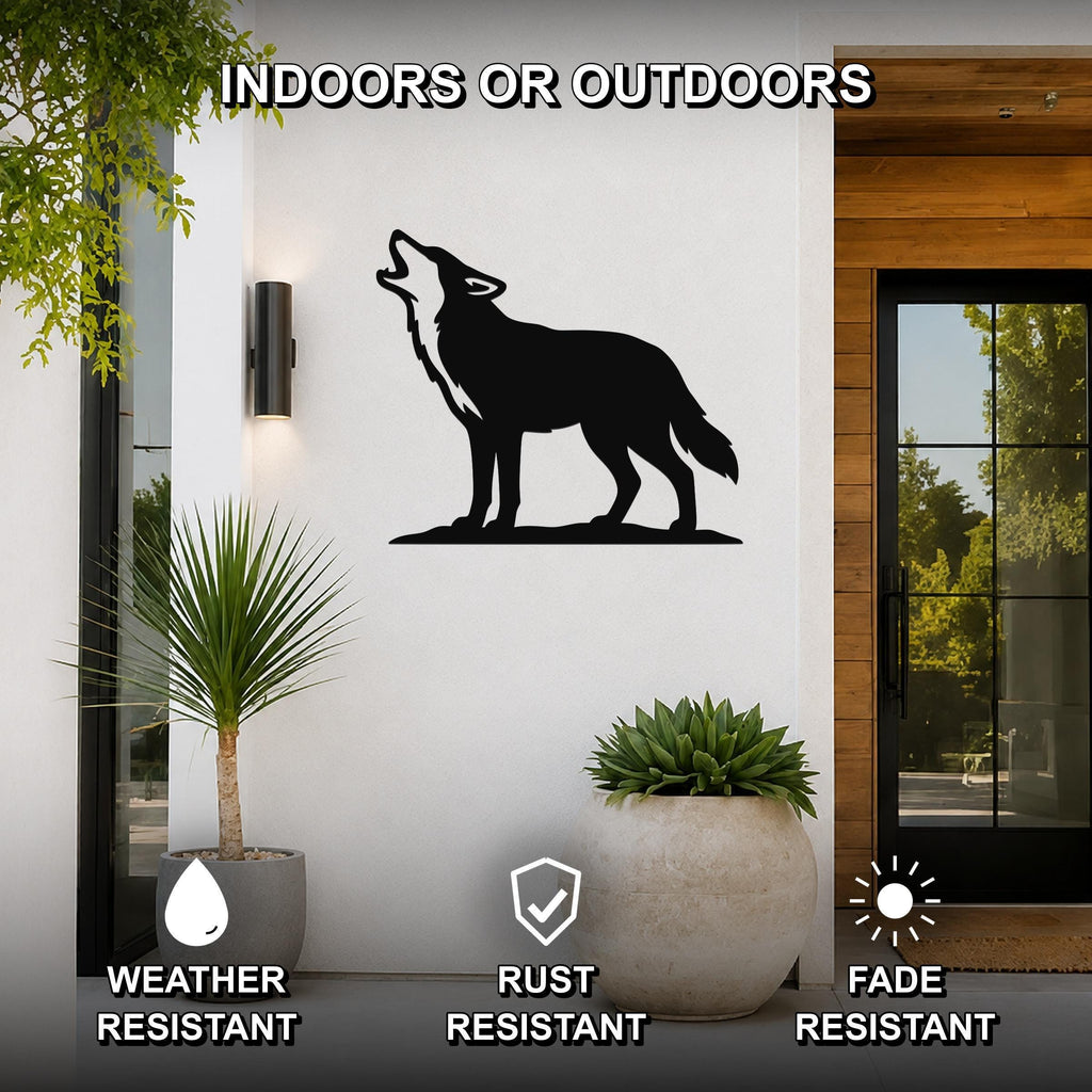 Black metal coyote wall art in a howling silhouette, mounted on a white exterior wall beside a glass door and potted plants, with text indicating it is weather, rust, and fade resistant.