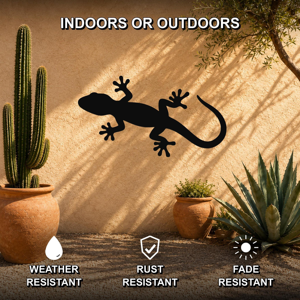 Black metal lizard wall art silhouette mounted on an outdoor stucco wall, surrounded by potted cacti and succulents in a sunny patio setting.