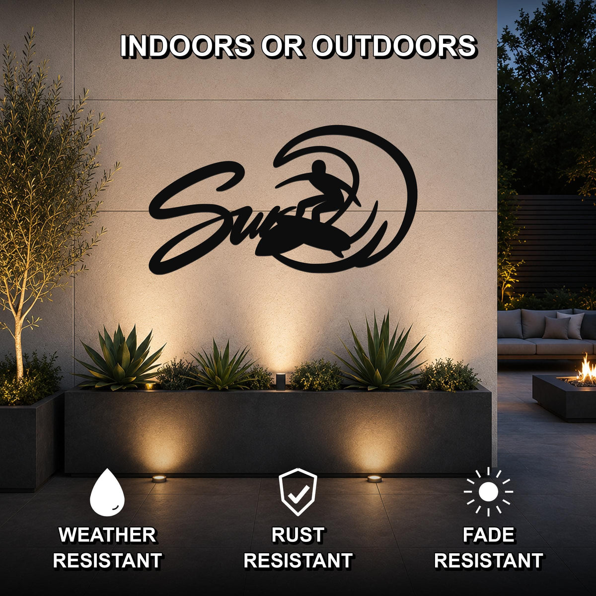Black metal surfer silhouette wall art with wave cutout, mounted on an outdoor wall above a planter in a modern patio setting.