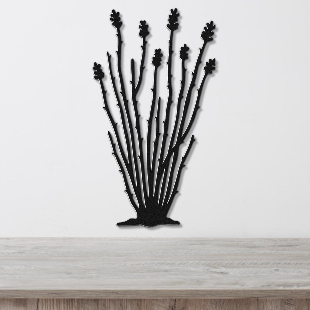 Black metal wall art cutout of an ocotillo plant with multiple spiny stems and leaf clusters, mounted on a white wall above a light wood surface.